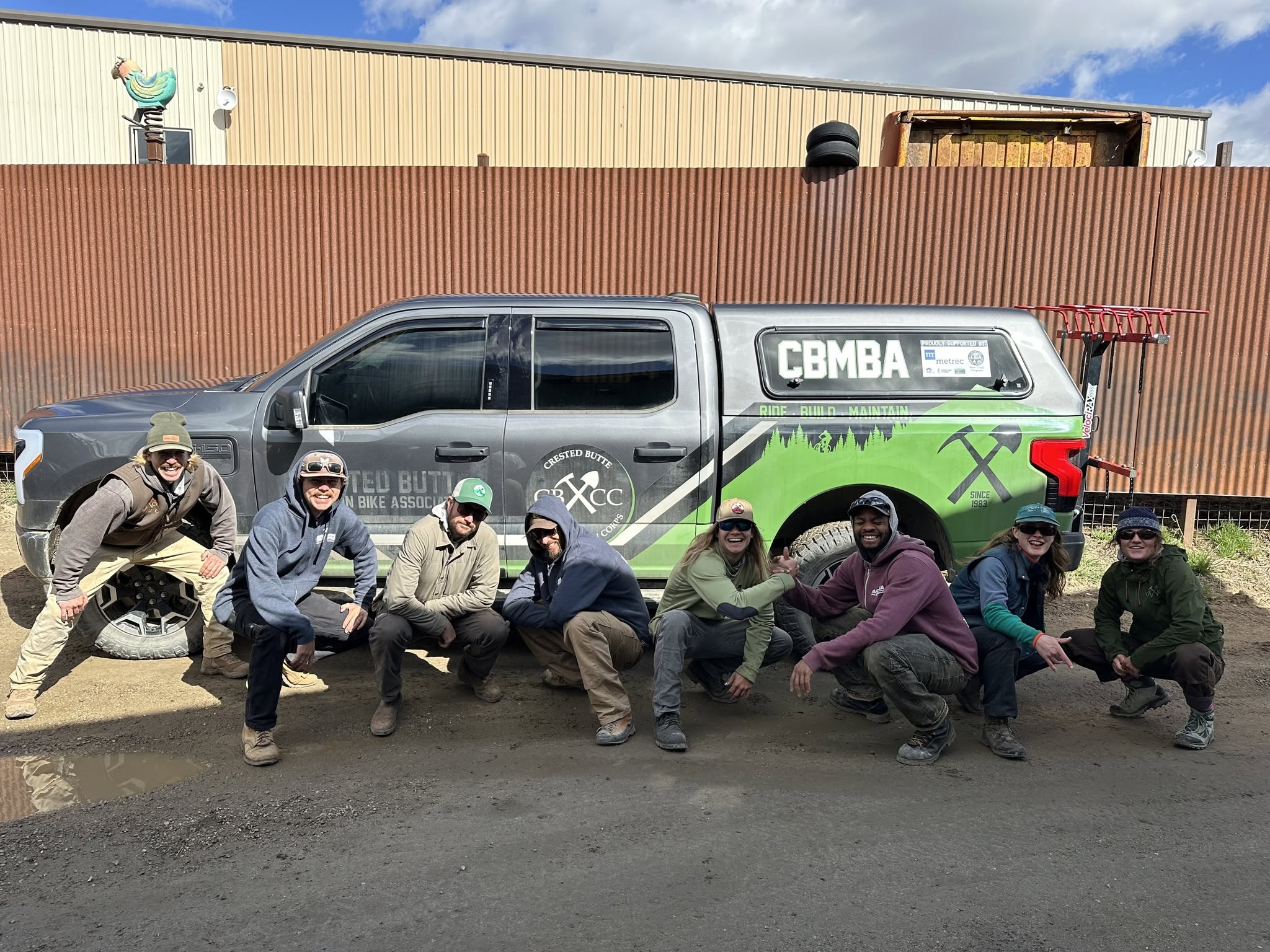 The CBMBA crew poses with a work truck.